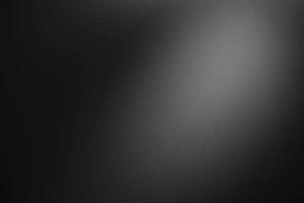 istock Dark black and gray blurred  gradient background has a little abstract light. 1403558273