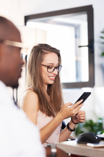 istock Business people having a creative meeting. Successful multiethnic multiracial colleagues in an office. Beautiful businesswoman looking at phone. 1403564863