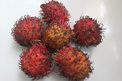 Fresh and ripe rambutan sweet tropical fruit.  Nephelium lappaceum. Selective focus, blurry background.