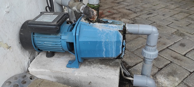 an outdated water pump that is still operational and useful, to meet water needs.