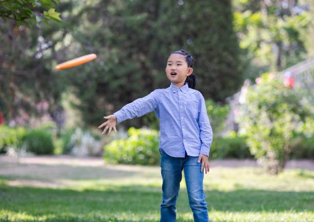 istock Little Girl Playing Frisbee 1403571339