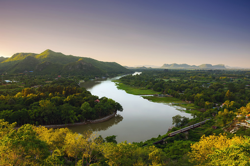 The beautiful landscape in the morning of the Kwai Noi River curve and the mountains at the Golden Chedi Viewpoint Wat Tham Khao Pun, Kanchanaburi.