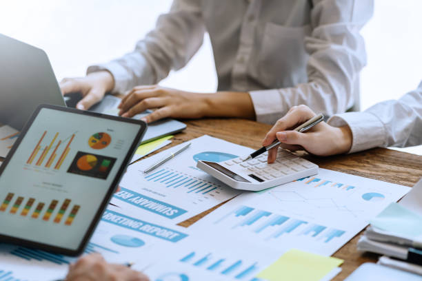 istock Business people discuss investment project working and planning strategy on digital tablet. Business people talking together with tablet at office. 1403575227