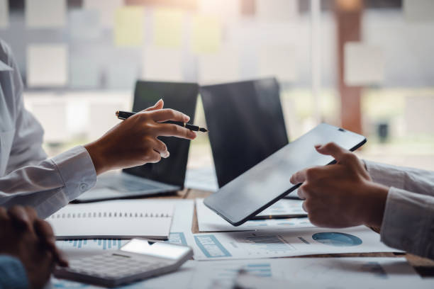 istock Business people discuss investment project working and planning strategy on digital tablet. Business people talking together with tablet at office. 1403575229