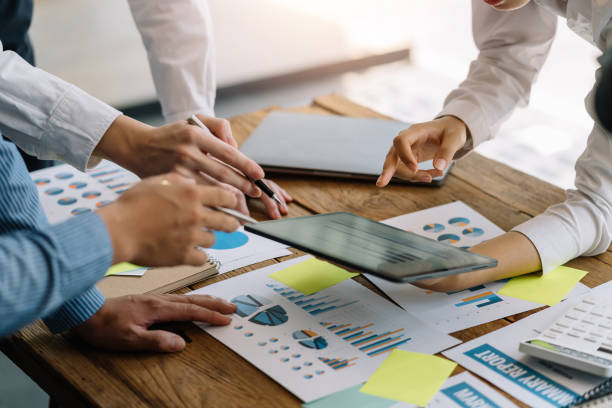 istock Business people discuss investment project working and planning strategy on digital tablet. Business people talking together with tablet at office. 1403575230
