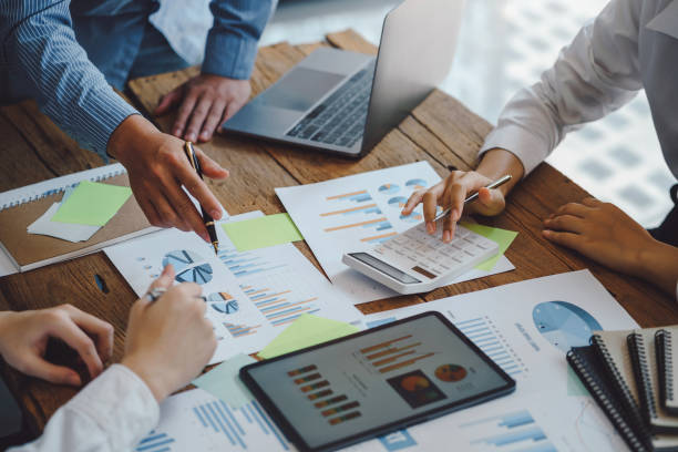 istock Business people discuss investment project working and planning strategy on digital tablet. Business people talking together with tablet at office. 1403575233
