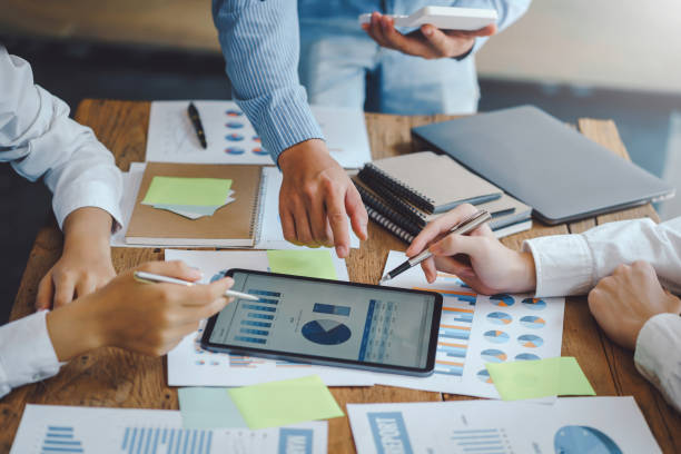 istock Business people discuss investment project working and planning strategy on digital tablet. Business people talking together with tablet at office. 1403575234