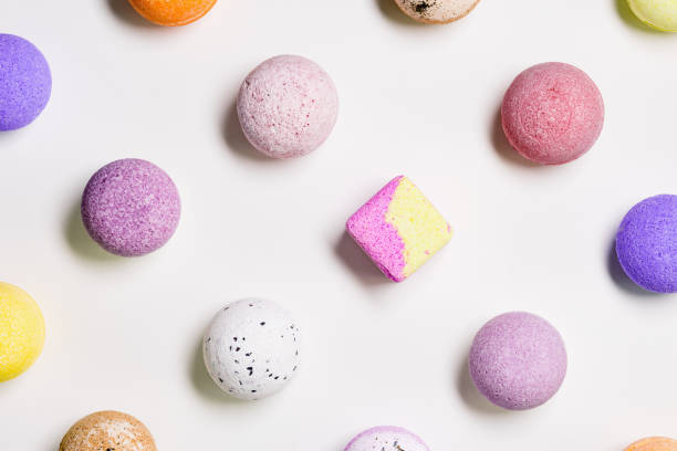 istock Pattern with colorful bath bombs on white paper background. Bathing balls with essential oil for relaxation and aromatherapy. Body care natural products. Colored cosmetic bomb for spa 1403584710