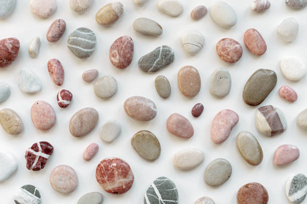 istock Top view close up sea stones on light background. Colorful pebbles as summer pattern. Natural stone white red pink grey colors. Minimal flat lay, background with natural materials 1403585178
