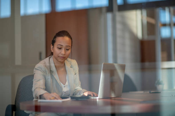 istock Businesswoman Working on her Laptop 1403586038