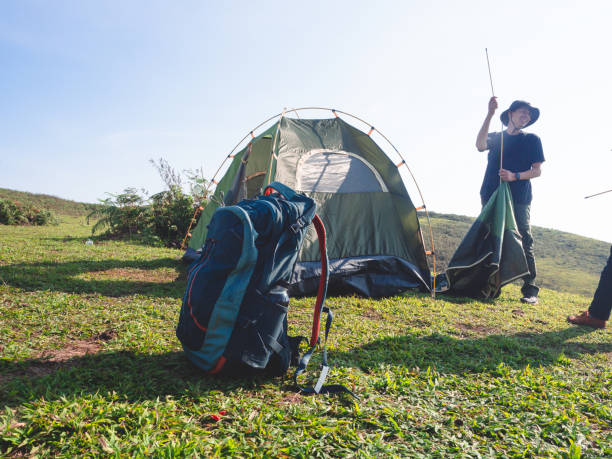 istock Friends camping on mountain peak. 1403586138