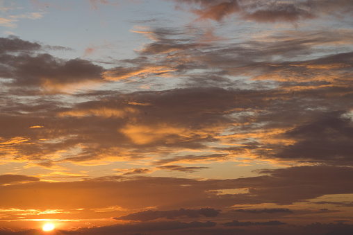 Tropical summer clouds are building to the wet season. The sunsets become spectacular with their blue, orange, yellow, red, purple and grey displays of color. soon the typhoons start and the skies put on an even more dramatic display