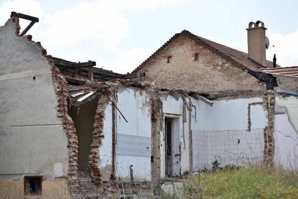 demolition of a residential tenement house in the city. demolition of a building. building in poor technical condition. displacement of people from apartments. construction site. falling apart old building.