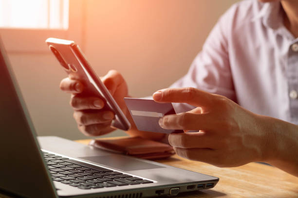 istock Businessman using laptop computer with a credit card making an online order. Business, online shopping, e-commerce, internet banking, spending money, online payment, working from home concept. 1403597180