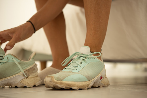 Close up of a woman putting her sport shoes on