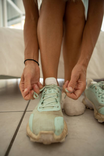istock Woman tying laces preparing for training 1403600391