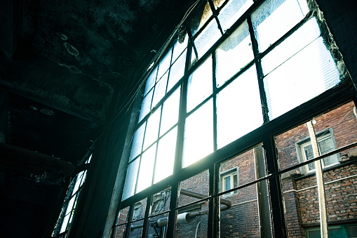 Abandoned industrial warehouse on ruined brick factory, creepy interior, perspective toned