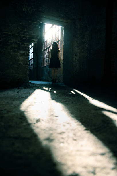 istock Woman in a destroyed building looking sunlight 1403601682