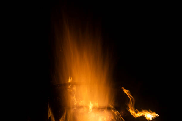 Texture of fire. Flames in night. Burning firewood. Bonfire in woods.