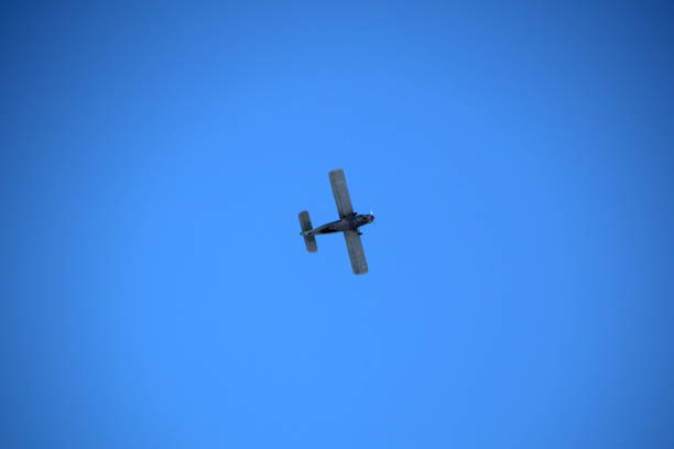 istock Retro small plane flies in the sky. 1403605262