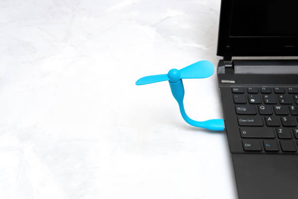 istock Portable usb fan connected to a laptop 1403605374