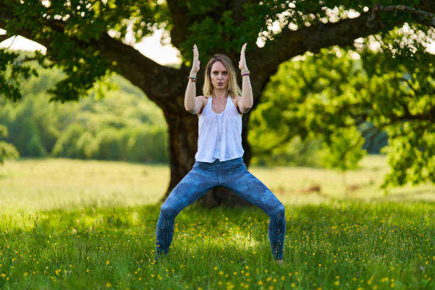 istock Young woman yoga practitioner in the forest 1403608897