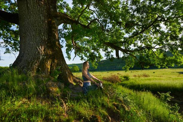 istock Young woman yoga practitioner in the forest 1403608969