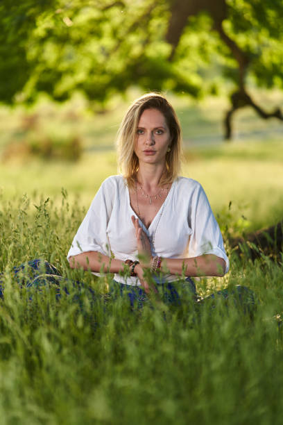 istock Young woman yoga practitioner in the forest 1403608977