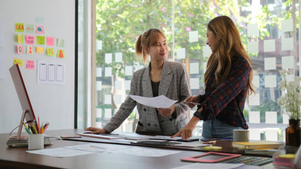 istock Young creative people are developing web applications for mobile phones together in the office. 1403610086