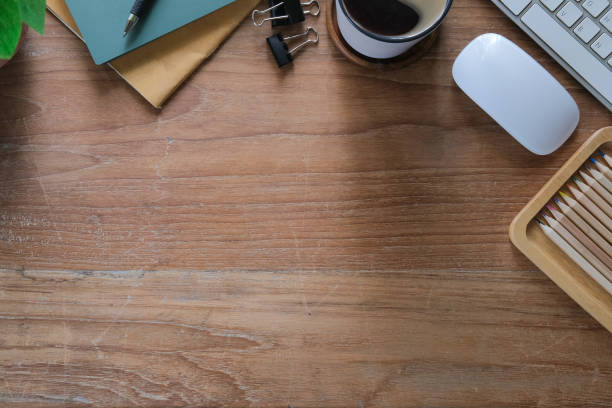 istock Above view simple workplace with books, coffee cup and pencils on wooden table. 1403611125