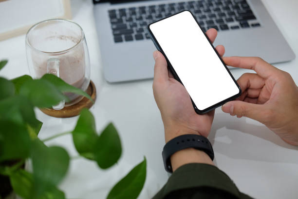 istock Close up view businessman hands holding smart phone. Blank screen for your text or information content. 1403612442