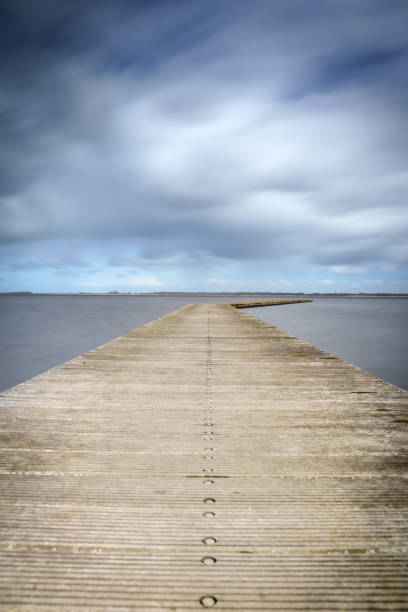istock Long bent Jetty on a Cold Day at a Dutch Lake 1403612800