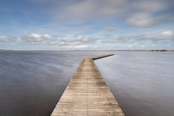 istock The wood bridge with clouds sky 1403612919