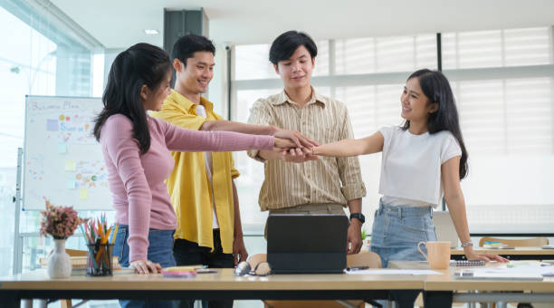 istock Overjoyed young business people celebrating success startup project together at office meeting.