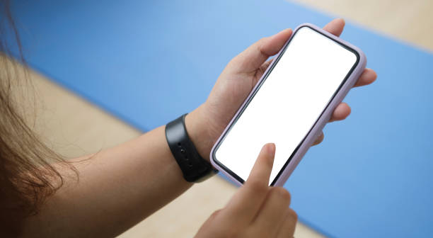 istock woman holding mock up smart phone with blank screen. 1403615862