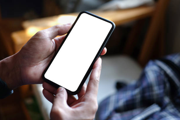 istock Close up view man hands holding smart phone with blank screen for advertise text. 1403616616