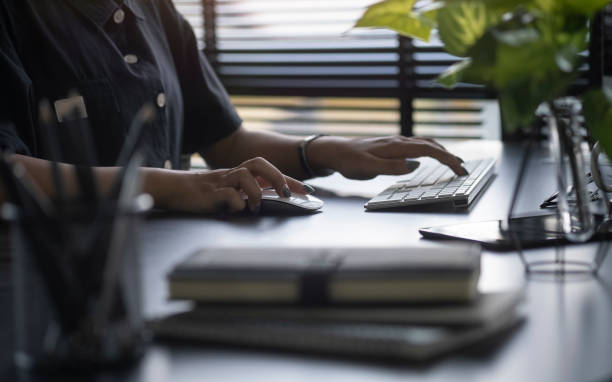 istock Close up view woman hands typing on computer.