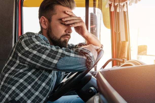 Tired truck driver feeling sleepy and sick stock photo