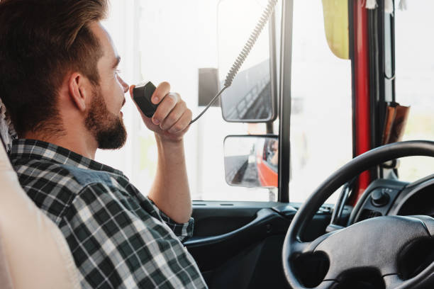 istock Truck driver talking by CB radio system in his vehicle 1403617408