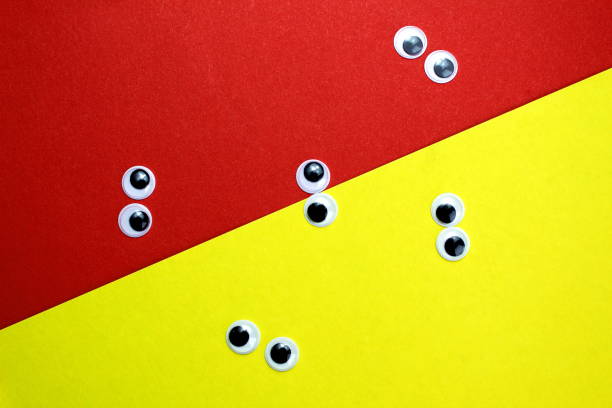 istock decorative eyes lie on yellow and red backgrounds. 1403618463