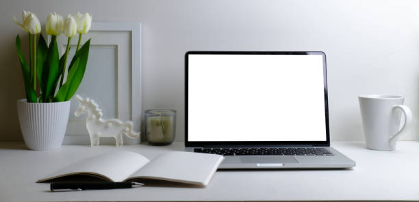 istock Workplace comfortable with computer laptop, coffee cup, notebook, picture frame and flower pot.