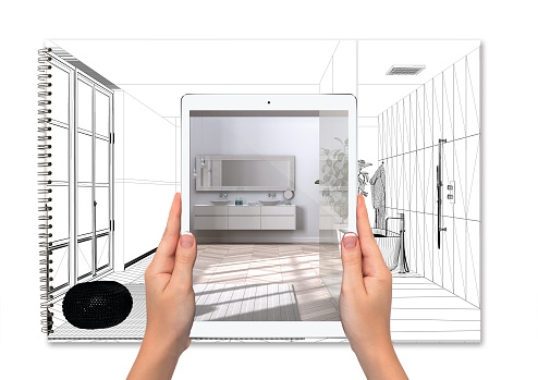 Hands holding tablet showing minimal luxury bathroom, total blank project background, augmented reality concept, application to simulate furniture and interior design products