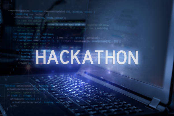 Hackathon inscription against laptop and code background. Technology concept. stock photo