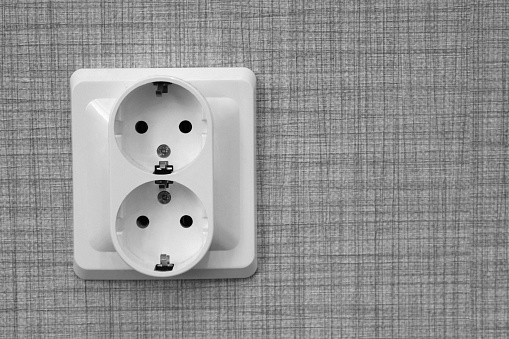 The double socket is attached to the wall.