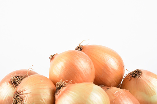 Front view group of onions on the white background with copy space