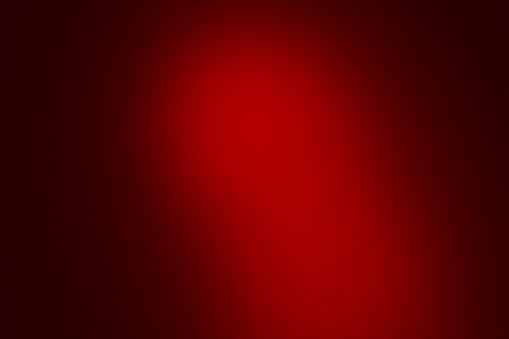 Abstract burgundy background with a light spot.