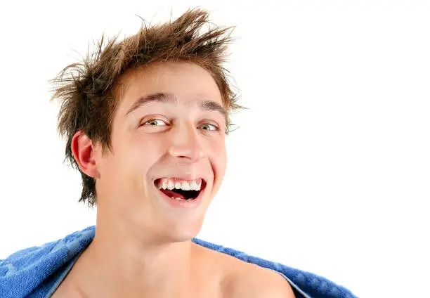 Happy Young Man Portrait with a Bath Towel Isolated on the White Background