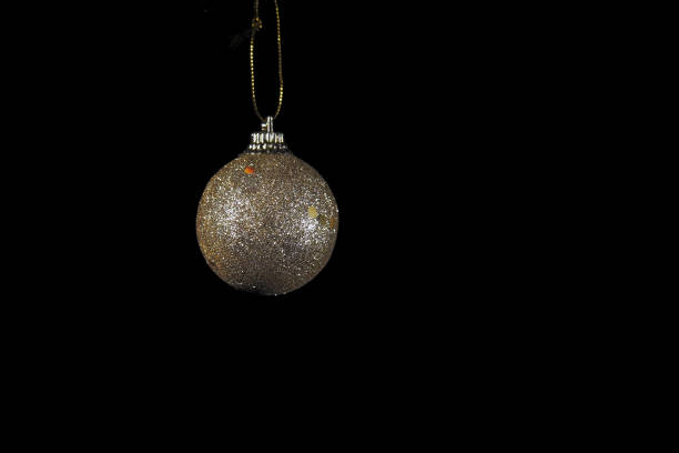istock Colden Christmas ball on black background. 1403626173