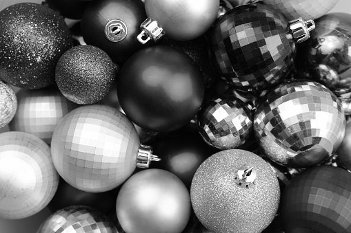 Texture of Christmas balls in one heap in gray.