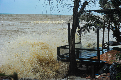 Strong winds and sea waves pound on the coast in the rainy season in southern Thailand